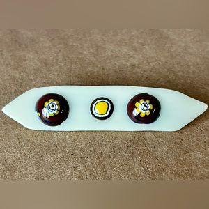 3” glass bar pin. Very good condition. Shades of off-white, brown and yellow.